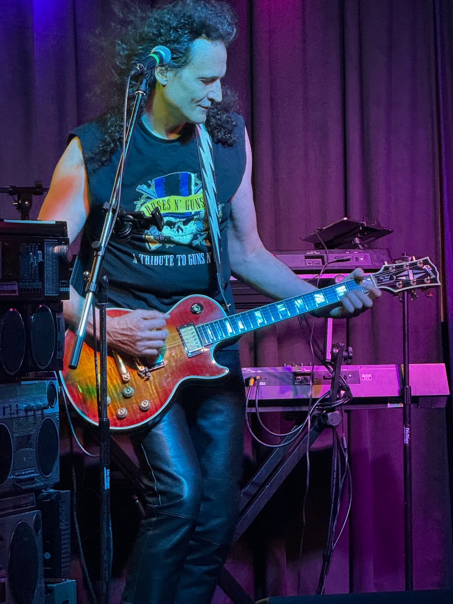 Aure of GEMS playing guitar live on stage