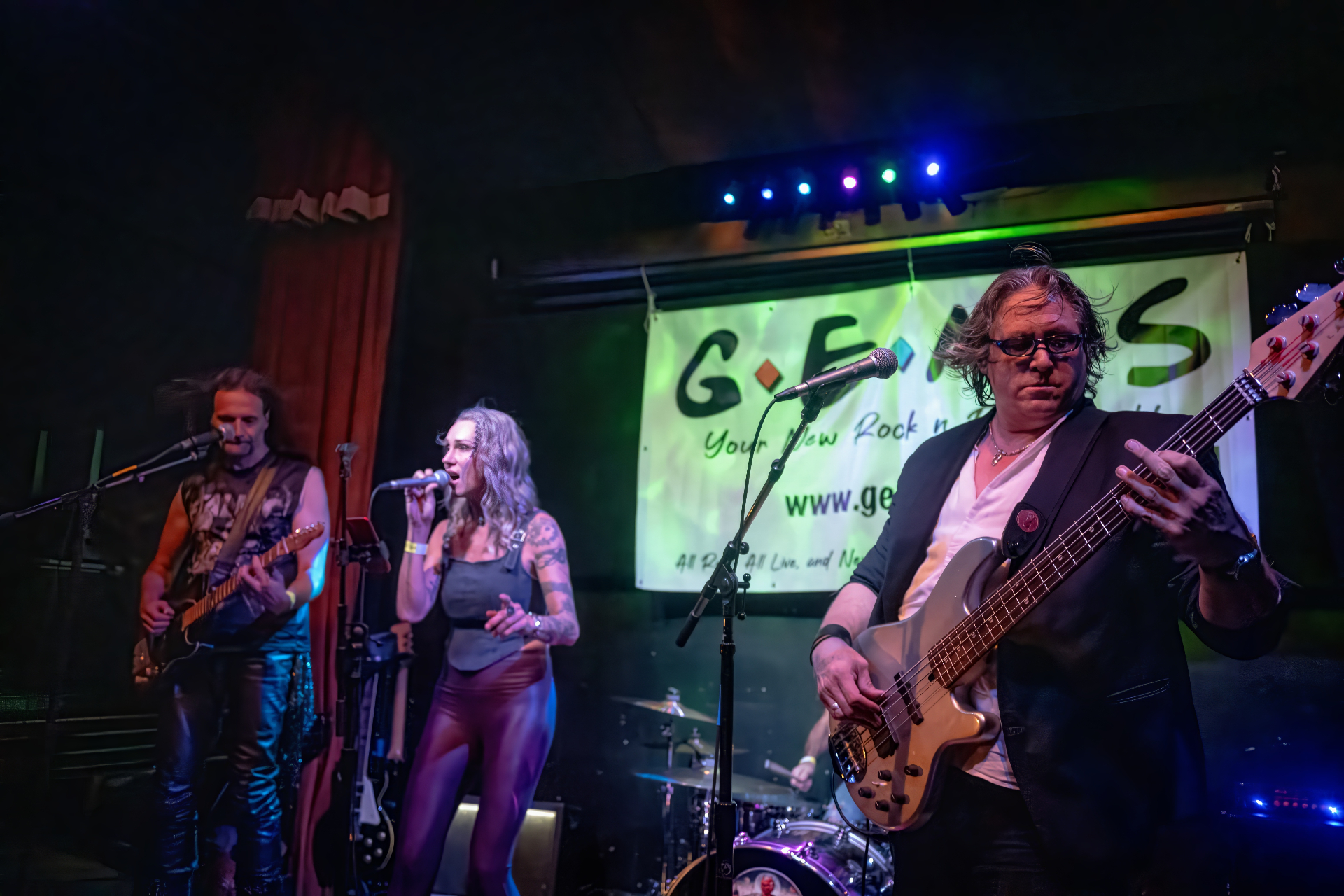 GEMS Bay Area cover band live under green stage lights