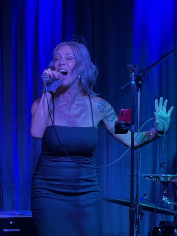 Meg of GEMS under blue stage lights at a Bay Area show